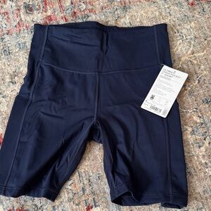 Athleta ultimate stash 7” pocket Navy High-Waisted Shorts
